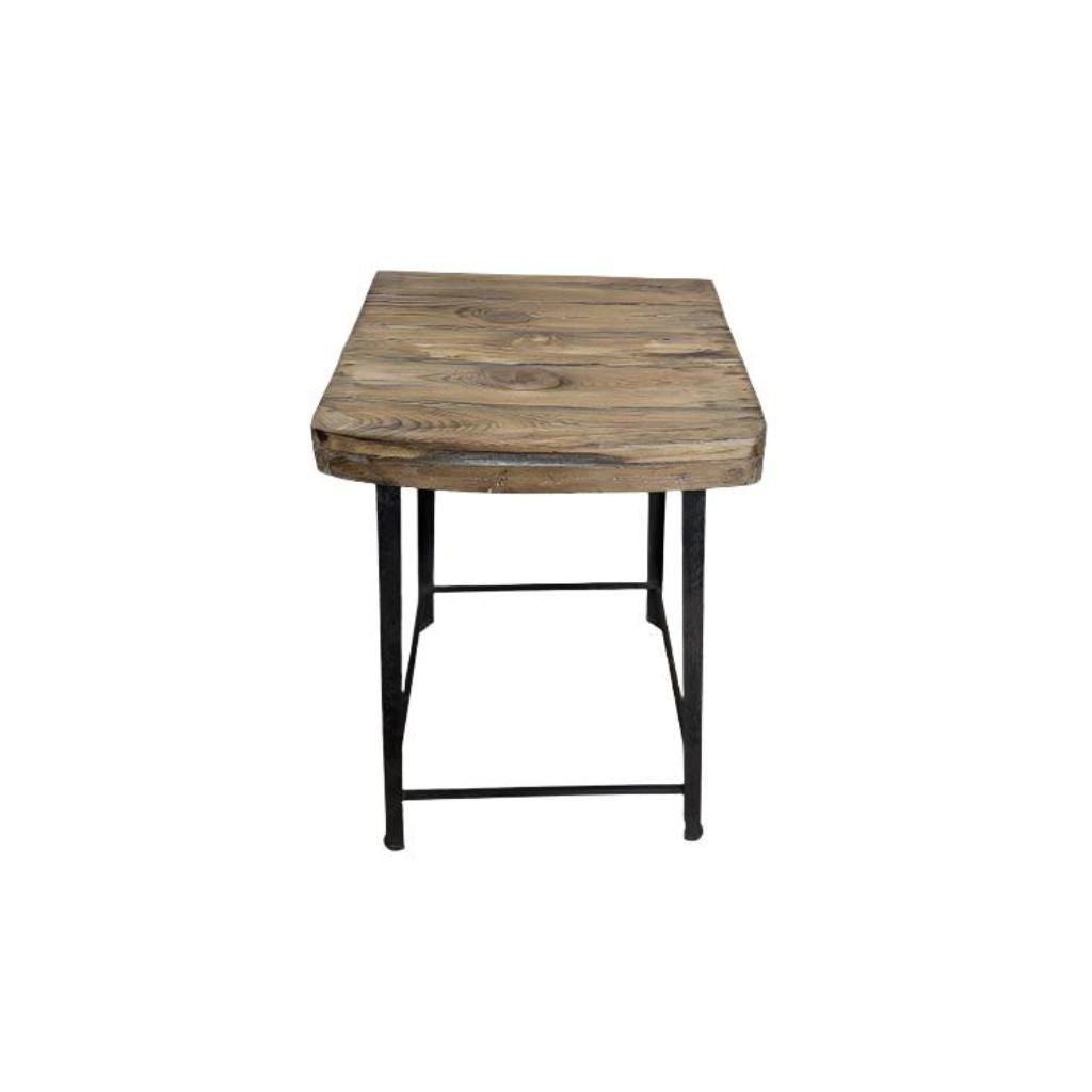 Square reclaimed wood stoll with cast iron blak legs with metal trim near the bottom, showing the wood seat.