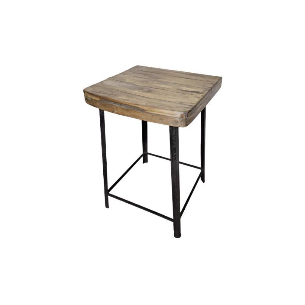 Square reclaimed wood stoll with cast iron blak legs with metal trim near the bottom.