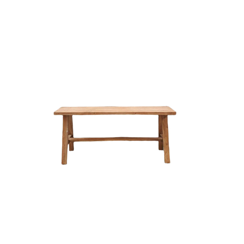 narrow bench handcrafted from natural reclaimed teak wood with 4 legs and a barre across. Showing the front view.