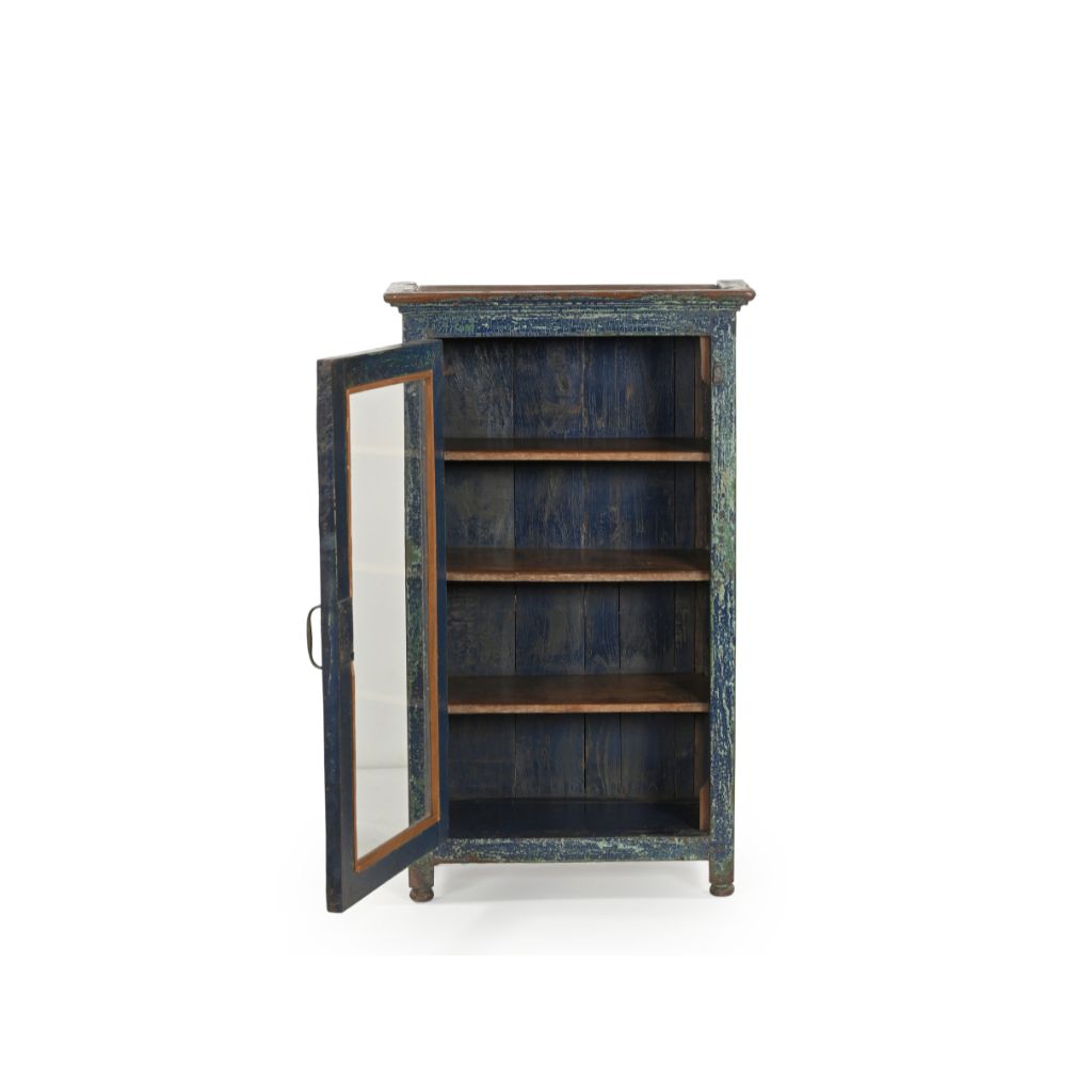 Small vintage wood cabinet with a glass door. It has 3 inner shelves and has a distressed blue patina. Showing the door open.