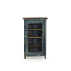 Small vintage wood cabinet with a glass door. It has 3 inner shelves and has a distressed blue patina. Front view.