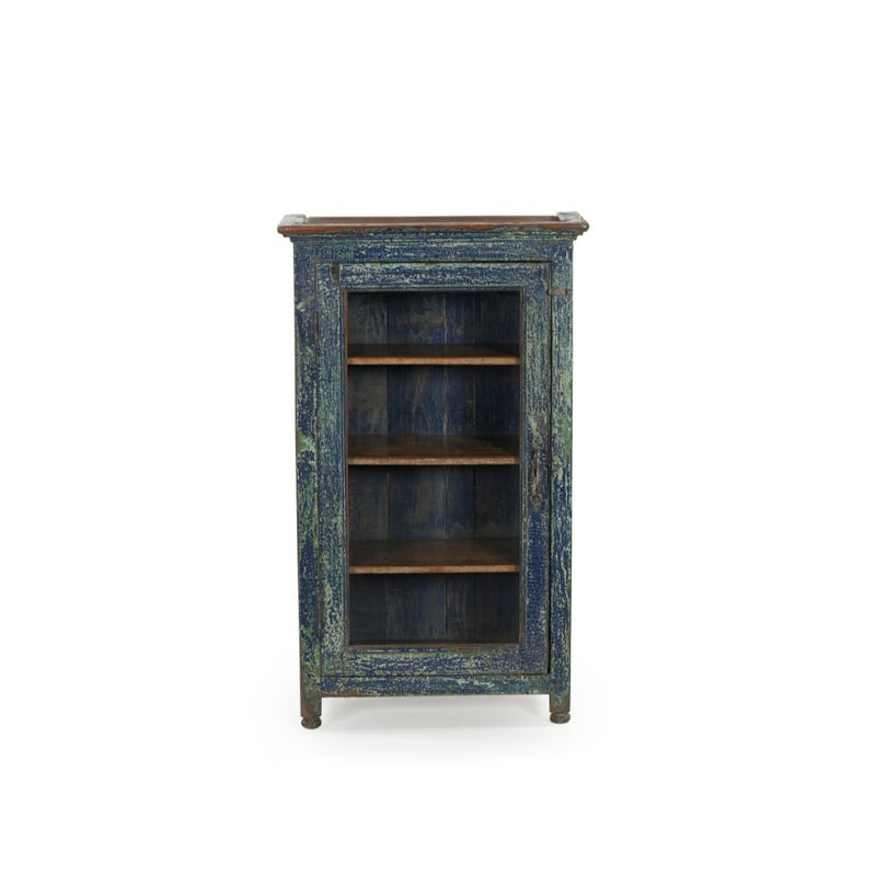 Small vintage wood cabinet with a glass door. It has 3 inner shelves and has a distressed blue patina. Front view.