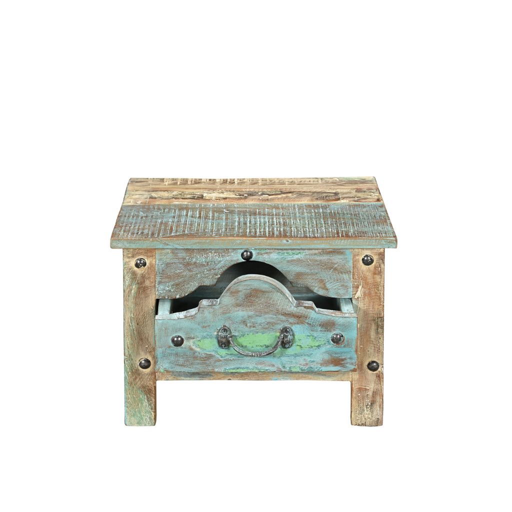 Small side table or bedside locker handcrafted from reclaimed wood with a blue patina. It has one front ornate drawer with rivets, showing drawer open.