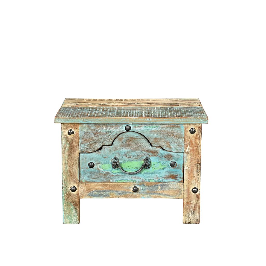 Small side table or bedside locker handcrafted from reclaimed wood with a blue patina. It has one front ornate drawer with rivets, front view.