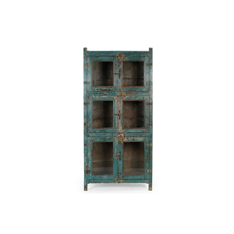 Vintage glass cabinet with 3 double glass doors for 3 separate compartments. The sides are 3 glass panels, the back and inner shelves are made of zinc. It has a blue distressed patina & 3 latches. Showing front view.
