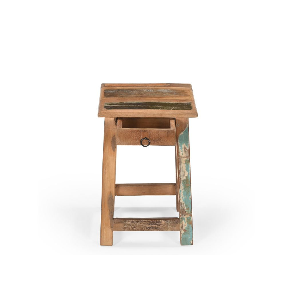 Small square stool with one tiny drawer under the seat. Made of reclaimed wood which had been previously painted, there's 4 legs with barres across the bottom.. Showing the drawer open.