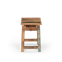 Small square stool with one tiny drawer under the seat. Made of reclaimed wood which had been previously painted, there's 4 legs with barres across the bottom.. Showing the drawer open.