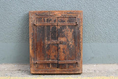 Dhaka mirror with natural wood against wall