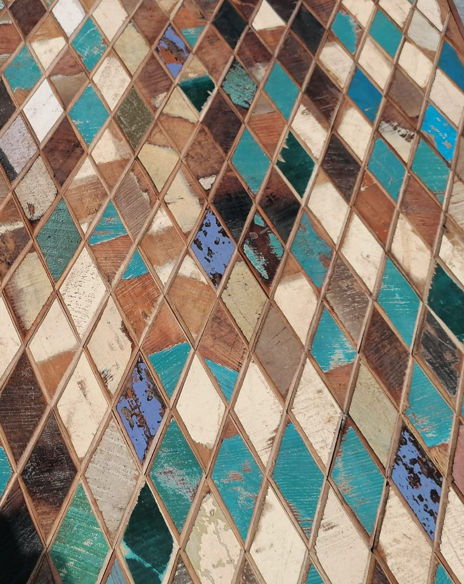 Harlequin Dining table made with mixed coloured reclaimed wood Close up of natural patina