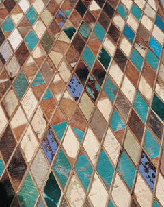 Harlequin Dining table made with mixed coloured reclaimed wood Close up of natural patina