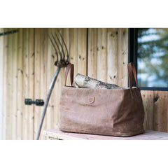 Log Bag Firewood Waxed Canvas Outside on top of workbench 