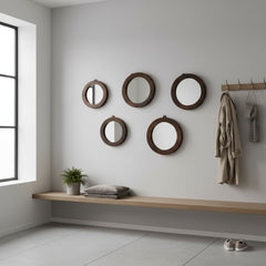 set of 5 small round mirrors with wood trim on a white wall