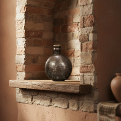 Round metallic flask on a stone alcove
