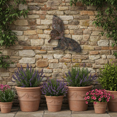 Decorative butterfly made of metal on a stone wall in a garden