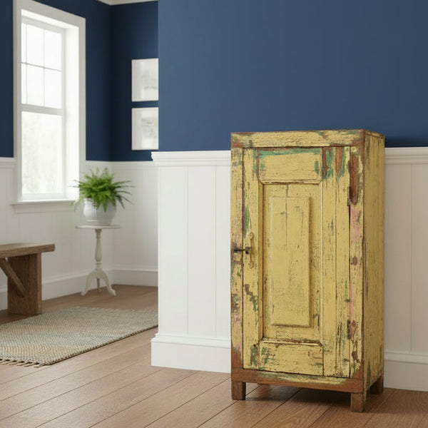 Vintage wooden cabinet with peeling paint in a hall