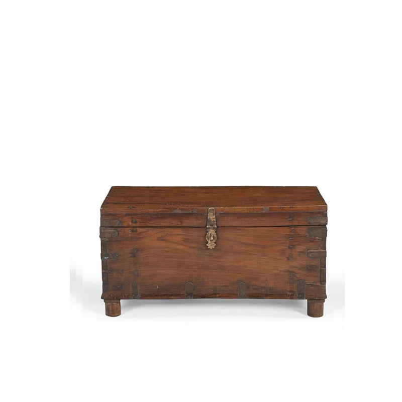 Wooden trunk with brass lock on a white background