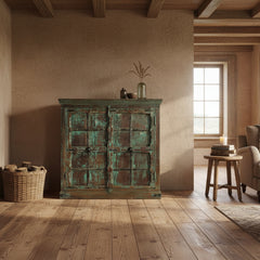 Vintage-style wooden cabinet with green and brown patina in a rustic style living room