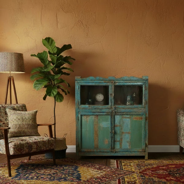 Vintage-style wooden cabinet with peeling blue paint in an eclectic style living room 