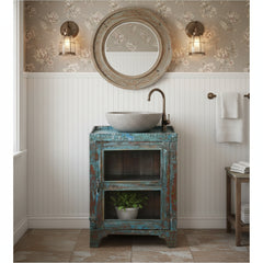 Vintage wooden & glass door cabinet with blue and brown patina in a bathroom