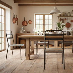 Chair with metal frame and striped wooden seat in a rustic kitchen around a wood dining table