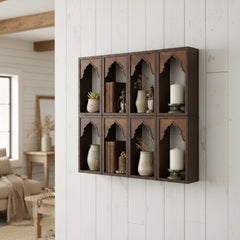 Wooden shelf with arched cutouts on a white wall