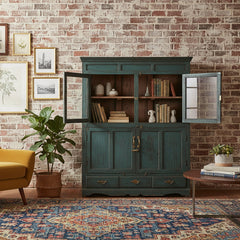 Vintage-style wooden cabinet with distressed blue finish in a rustic living room