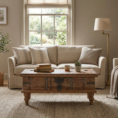 natural wood small trunk on legs with a big latch in a living room as a coffee table