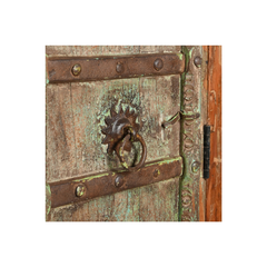 A square decorative print or tile featuring a close-up of an antique wooden door with weathered metal bands, a rusted metal knocker, and a hinge, centered on a white background.