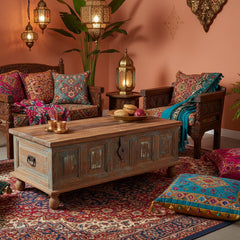 Wooden storage trunk with distressed blue panel n an exotic style living room as a coffee table