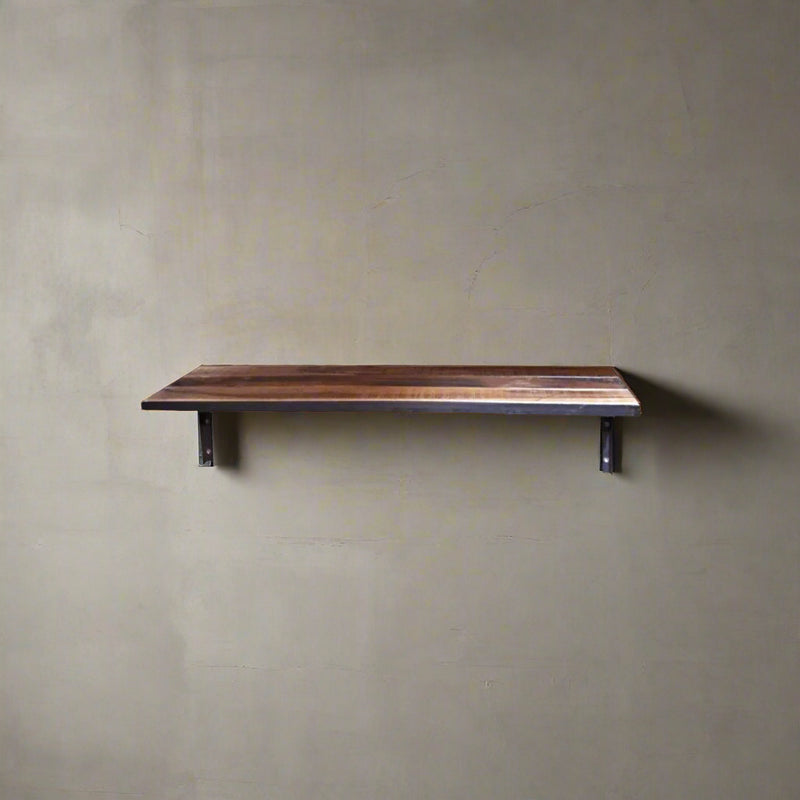 Reclaimed wood shelf with black metal casing & black metal brackets on a grey wall front view