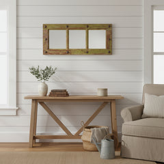 Rustic wooden mirror with three panels on a white wall in a farm house interior