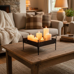 Square metal tray on short legs in a living room with candles