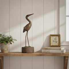 Siver sculpture of a heron on a shelf