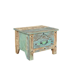 Small side table or bedside locker handcrafted from reclaimed wood with a blue patina. It has one front ornate drawer with rivets, side view.