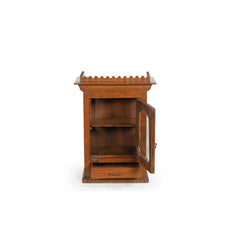 Light teak wood wall glass cabinet showing the door & drawer open. The top of the cabinet has an ornate trim around.