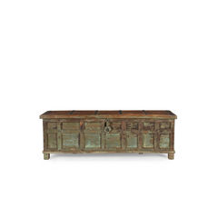 A rustic, weathered wooden storage chest with a distressed green and brown patina, featuring a central metal lock, set against a plain white background.