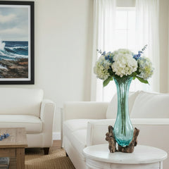 Decorative vase with a blue glass body and wooden base in a living room
