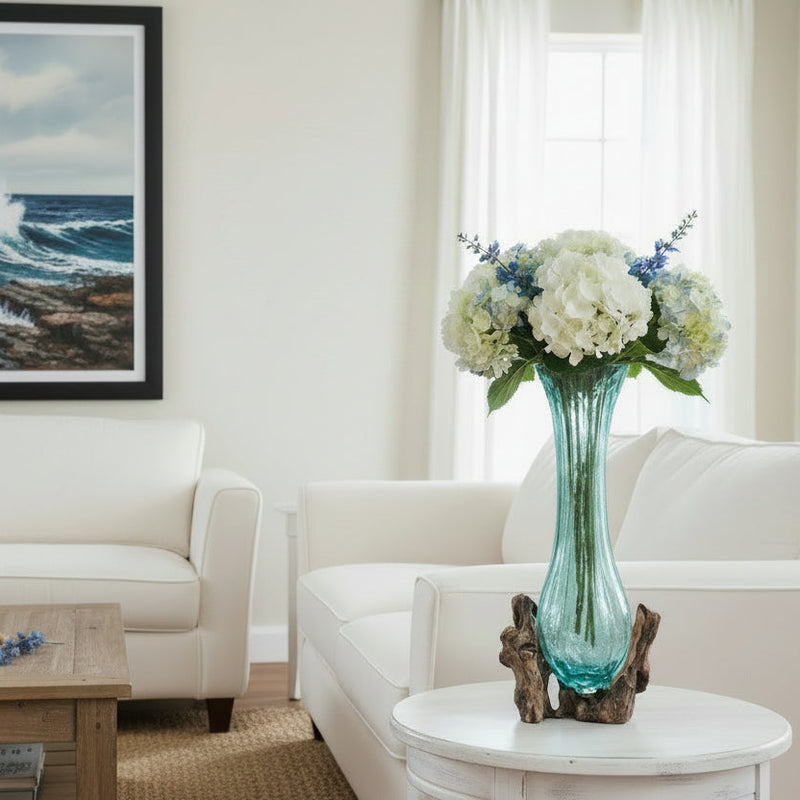 Decorative vase with a blue glass body and wooden base in a living room