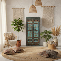 Vintage-style wooden cabinet with distressed turquoise paint in a boho living room
