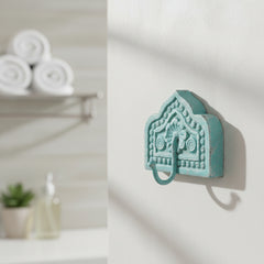 Small metal hook on a piece of carved wood blue