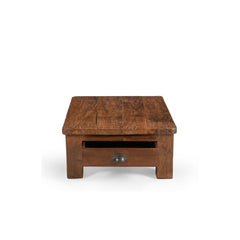 Wooden coffee table with a single drawer on a white background