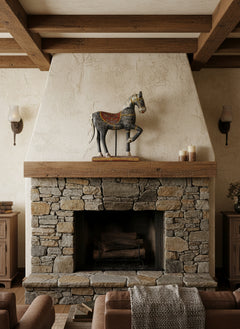 wooden horse on a mantle piece in a rustic interior
