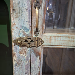 Vintage wooden door with ornate brass handle and hinge