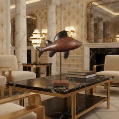 Wooden fish sculpture on a stand in an art deco interior