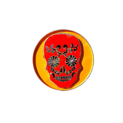 Metal sculpture of a decorated skull red on orange backround in 3D