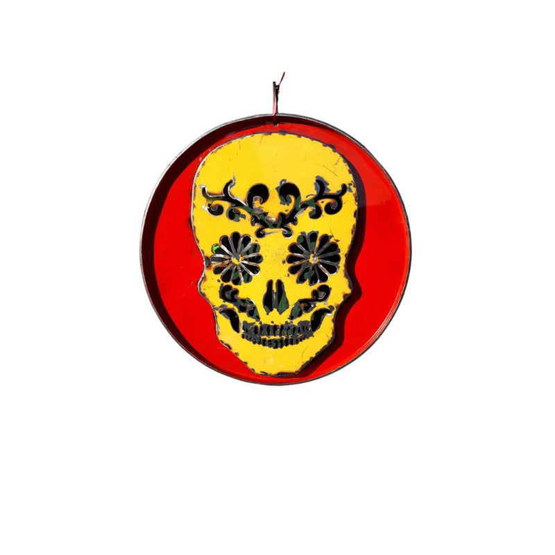 Metal sculpture of a decorated skull yellow on red backround in 3D