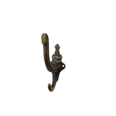 Cast iron hook in the shape of an elephant head with the trunk & tusk as hooks showing front view