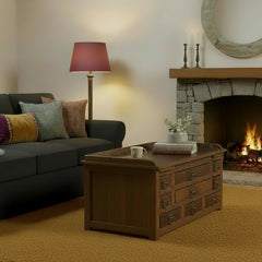 Teak vintage coffee table with multiple drawers in a living room in front of a dark grey sofa 
