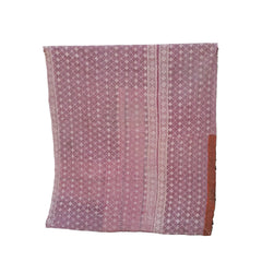 A pink patterned textile, likely a vintage shawl or throw, draped over a black metal stand against a white background