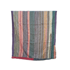 A multicolor striped patchwork quilt with vertical bands of pink, green, purple, and beige patterns, draped over a black metal rolling rack against a white background